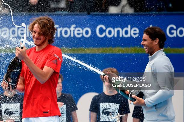 Spain's Rafael Nadal pours champagne on Greece's Stefanos Tsitsipas after winning their Barcelona Open ATP tournament final tennis match in Barcelona...