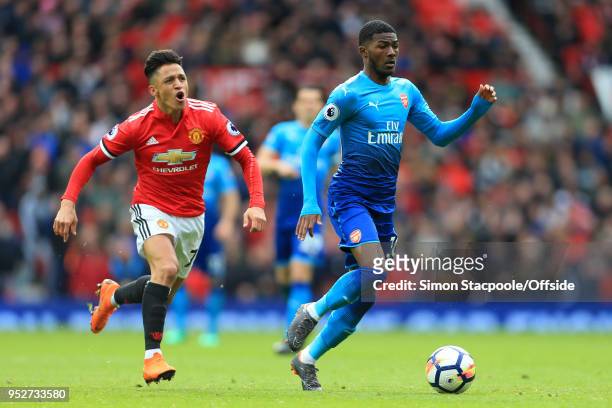 Ainsley Maitland-Niles of Arsenal gets away from Alexis Sanchez of Man Utd during the Premier League match between Manchester United and Arsenal at...