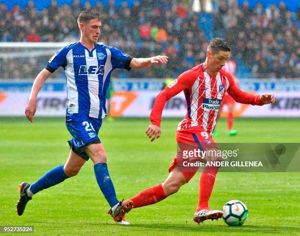 Atletico Madrid's forward Fernando Torres challenges Alaves' Spanish defender Adrian Dieguez during the Spanish league football match Deportivo...