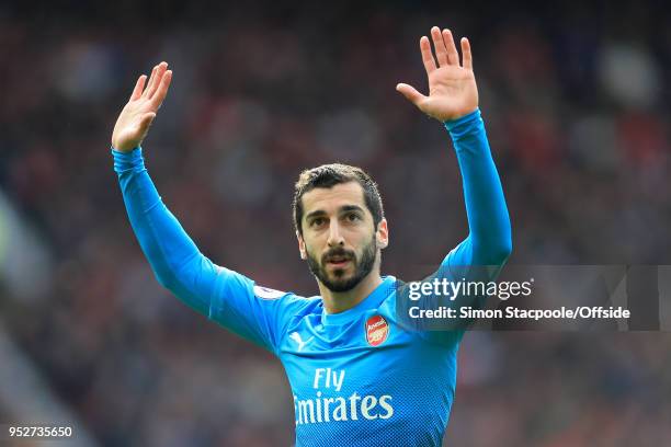 Henrikh Mkhitaryan of Arsenal apologises to the home fans as he celebrates after scoring their 1st goal during the Premier League match between...