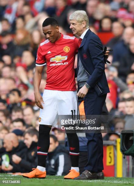 Anthony Martial of Manchester United speaks to Arsene Wenger, Manager of Arsenal as he prepares to come on during the Premier League match between...