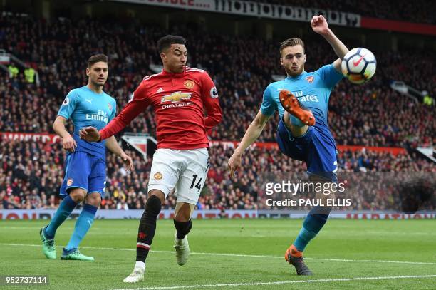 Arsenal's English defender Calum Chambers vies with Manchester United's English midfielder Jesse Lingard during the English Premier League football...