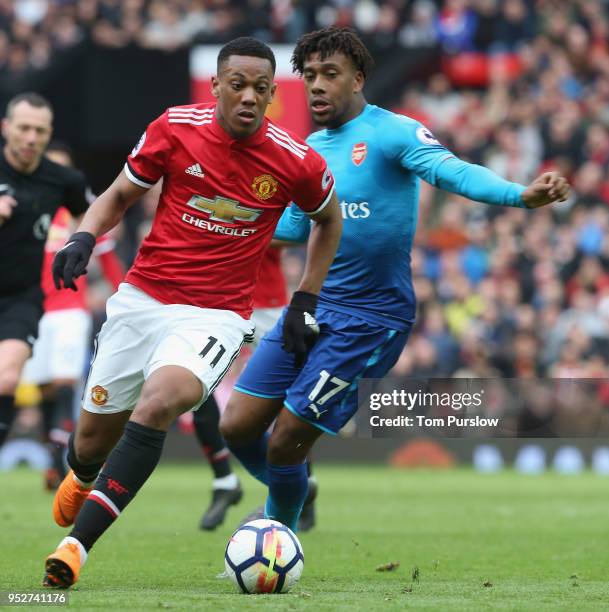 Anthony Martial of Manchester United in action with Alex Iwobi of Arsenal during the Premier League match between Manchester United and Arsenal at...