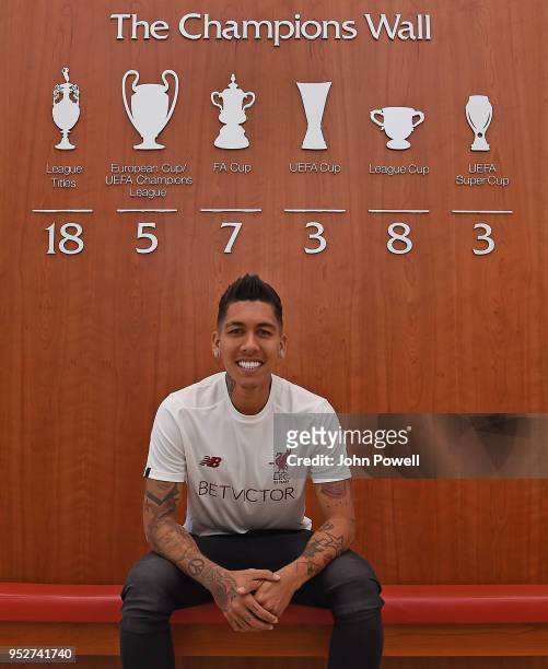 Roberto Firmino poses after he signs his new contract at Melwood Training Ground on April 29, 2018 in Liverpool, England.