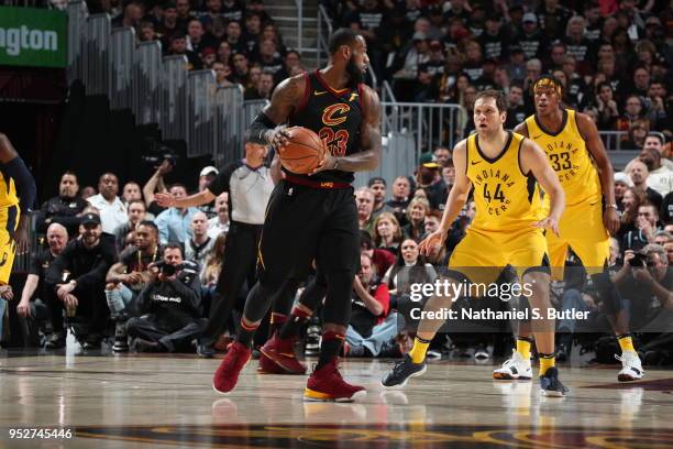 LeBron James of the Cleveland Cavaliers handles the ball against Bojan Bogdanovic of the Indiana Pacers in Game Seven of Round One of the 2018 NBA...