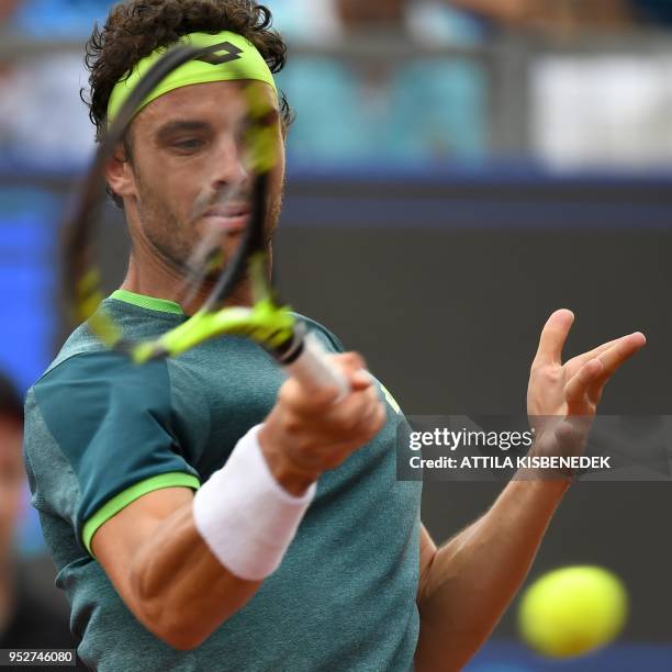 Italian Marco Cecchinato returns the ball to Australian John Millman during heir ATP final tennis match at the Hungarian Open in Budapest, on April...