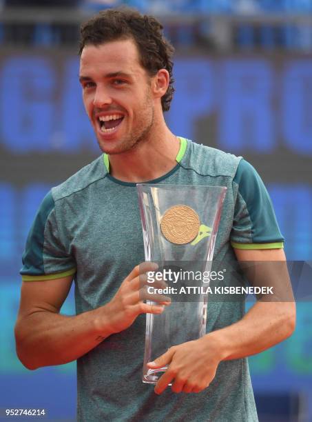 Italian Marco Cecchinato poses with the trophy after his victory over Australian John Millman at the end of their ATP final tennis match at the...