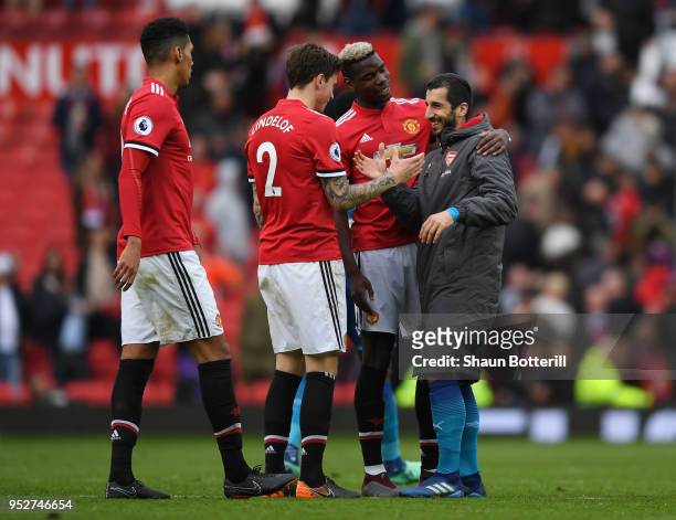 Henrikh Mkhitaryan of Arsenal embraces his former Manchester United teammates, Paul Pogba, and Victor Lindelof following the Premier League match...