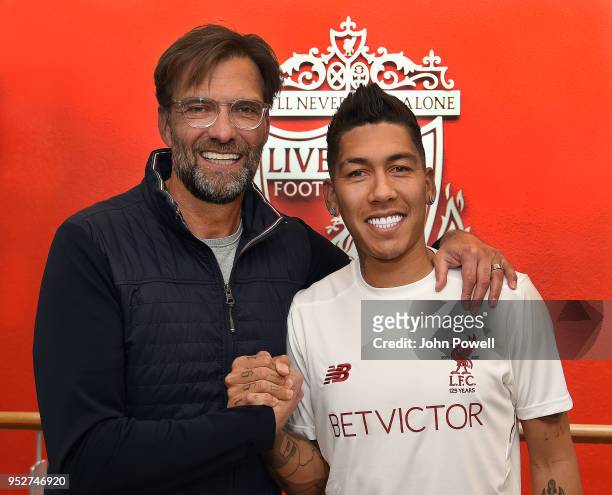 Roberto Firmino with Liverpool manager Jurgen Klopp after he signs his new contract at Melwood Training Ground on April 29, 2018 in Liverpool,...