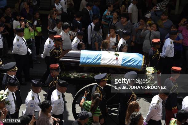 The frag-draped coffin of Guatemala City Mayor and former Guatemalan President Alvaro Arzu is escorted by military personnel during his funeral as...