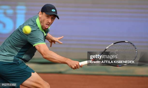 Australian John Millman returns the ball to Italian Marco Cecchinato during their ATP final tennis match at the Hungarian Open in Budapest, on April...