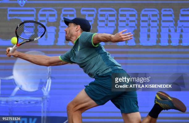 Australian John Millman returns the ball to Italian Marco Cecchinato during their ATP final tennis match at the Hungarian Open in Budapest, on April...