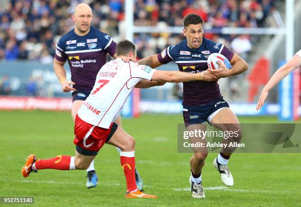 Danny McGuire of Hull KR attempts to tackle Joel Moon of Leeds Rhinos during the BetFred Super League match between Hull KR and Leeds Rhinos at KCOM...