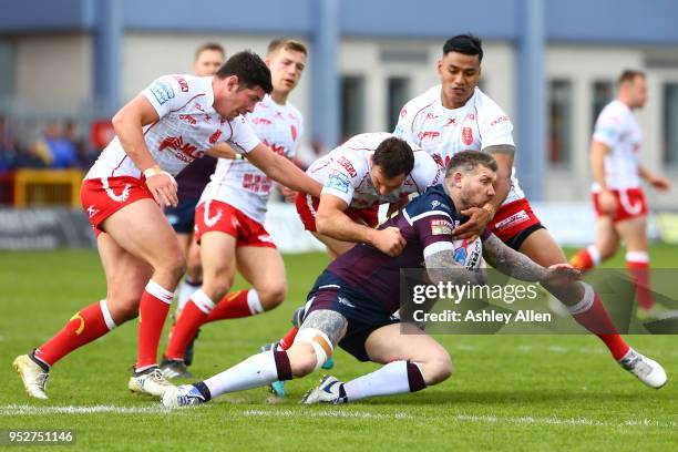 Brett Delaney of Leeds Rhinos is tackled during the BetFred Super League match between Hull KR and Leeds Rhinos at KCOM Craven Park on April 29, 2018...