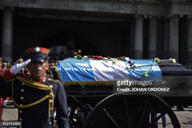 The frag-draped coffin of Guatemala City Mayor and former Guatemalan President Alvaro Arzu is escorted by military personnel during his funeral as...