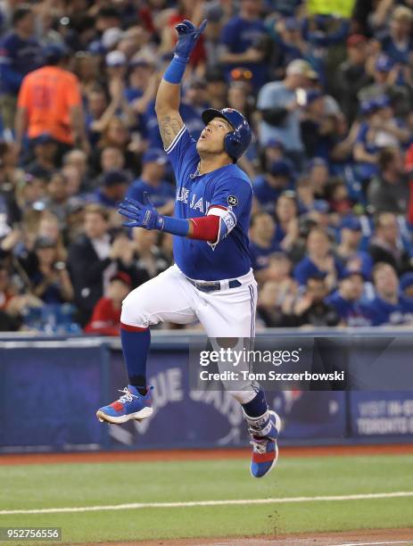 Yangervis Solarte of the Toronto Blue Jays celebrates after hitting a solo home run in the second inning during MLB game action against the Texas...