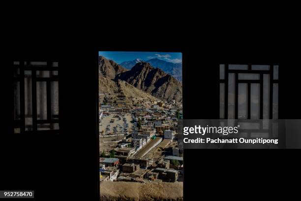 landscape of mountains and central city of leh through the window, leh, india - leh district stock-fotos und bilder