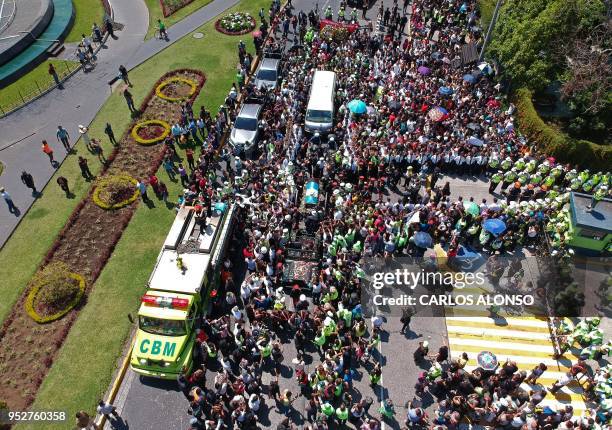 The frag-draped coffin of Guatemala City Mayor and former Guatemalan President Alvaro Arzu is escorted by military personnel during his funeral as...