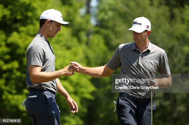 Jamie Lovemark and Brendan Steele react to their putt on the first hole during the final round of the Zurich Classic at TPC Louisiana on April 29,...