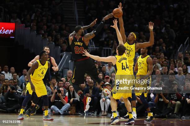 LeBron James of the Cleveland Cavaliers passes around Myles Turner of the Indiana Pacers during the first half in Game Seven of the Eastern...