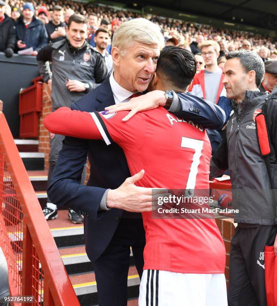 Arsenal manager Arsene Wenger hugs ex player Alexis Sanchez before the Premier League match between Manchester United and Arsenal at Old Trafford on...