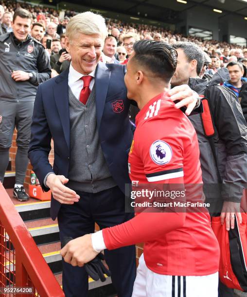 Arsenal manager Arsene Wenger hugs ex player Alexis Sanchez before the Premier League match between Manchester United and Arsenal at Old Trafford on...