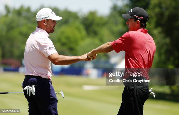 Kevin Kisner and Scott Brown react to a putt on the first hole during the final round of the Zurich Classic at TPC Louisiana on April 29, 2018 in...