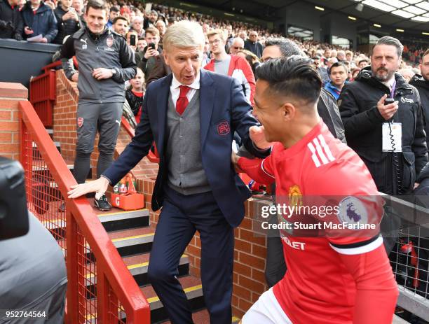 Arsenal manager Arsene Wenger hugs ex player Alexis Sanchez before the Premier League match between Manchester United and Arsenal at Old Trafford on...