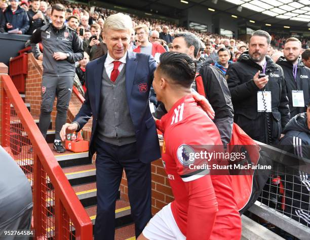 Arsenal manager Arsene Wenger hugs ex player Alexis Sanchez before the Premier League match between Manchester United and Arsenal at Old Trafford on...