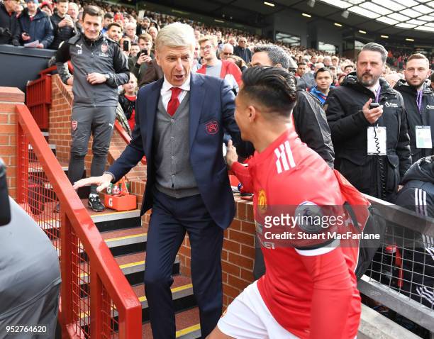 Arsenal manager Arsene Wenger hugs ex player Alexis Sanchez before the Premier League match between Manchester United and Arsenal at Old Trafford on...