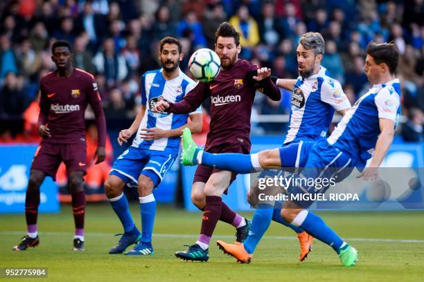 Barcelona's Argentinian forward Lionel Messi challenges Deportivo La Coruna's Portuguese defender Luisinho during the Spanish league football match...