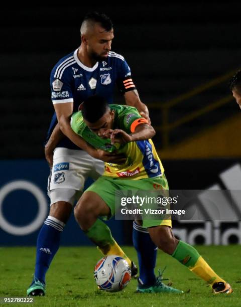 Andrés Cadavid of Millonarios fights for the ball with Omar Duarte of Atletico Huila during a match between Millonarios and Atletico Huila at Nemesio...