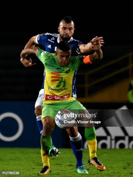 Andrés Cadavid of Millonarios fights for the ball with Omar Duarte of Atletico Huila during a match between Millonarios and Atletico Huila at Nemesio...