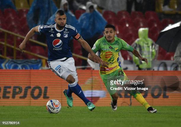 Andres Cadavid of Millonarios fights for the ball with Freyn Figueroa of Atletico Huila during a match between Millonarios and Atletico Huila at...