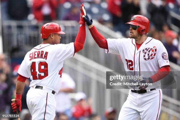 Matt Wieters of the Washington Nationals celebrates hitting a solo home run in the second inning with Moises Sierra during a baseball game against...