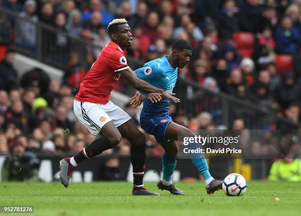 Ainsley Maitland-Niles of Arsenal is challenged by Paul Pogba of Man Utd during the Premier League match between Manchester United and Arsenal at Old...