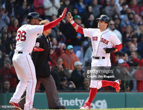 Eduardo Nunez of the Boston Red Sox greets Andrew Benintendi after they scored on a hit by J.D. Martinez in the sixth inning against the Tampa Bay...