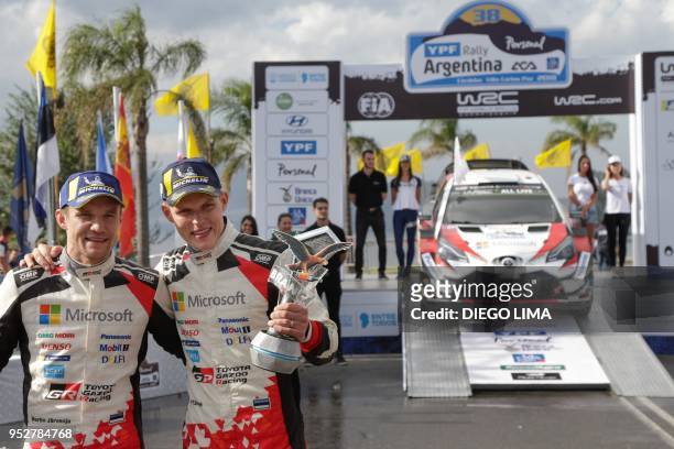 Estonian driver Ott Tanak and his compatriot co-driver Martin Jarveoja celebrate their win on the final podium of the Argentina World Rally...
