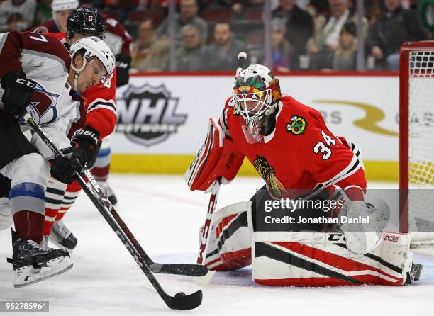 Gabriel Bourque of the Colorado Avalanche gets off a shot at J-F Berube of the Chicago Blackhawks at the United Center on March 6, 2018 in Chicago,...