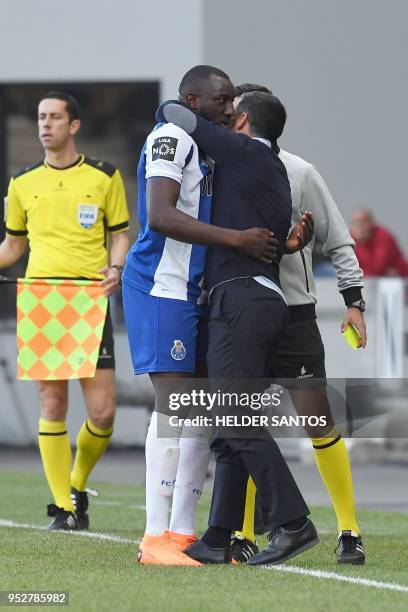 Porto's Malian forward Moussa Marega hugs coach Sergio Conceicao during the Portuguese league football match between Maritimo and Porto at the...