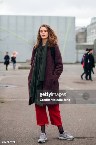 Model Ellen Vang wears a green scarf, purple coat, red pants, and gray New Balance sneakers at Copenhagen Fashion Week Autumn/Winter 18 on February...