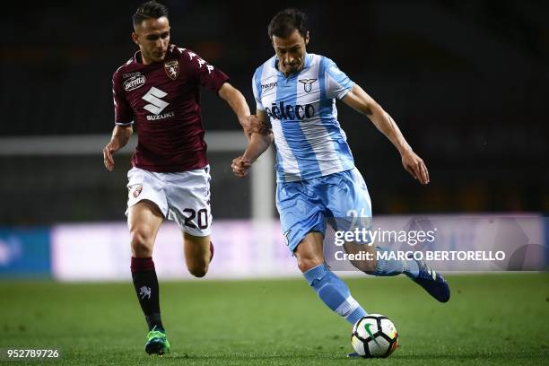 Torino's Italian forward Simone Edera fights for the ball with Lazio's Romanian defender Stefan Radu during the Italian Serie A football match...