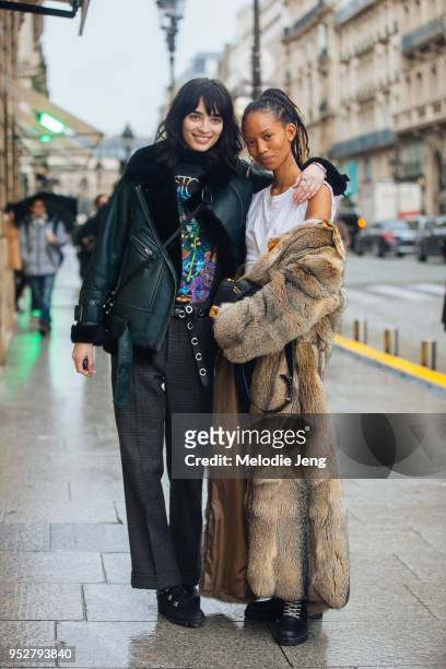 Models Cristina Piccone, Adesuwa Aighewi on January 22, 2018 in Paris, France. Cris wears all-black - a shearling leather bomber jacket, band-tshirt,...