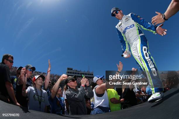 Ty Dillon, driver of the GEICO Chevrolet, walks across the stage during driver introductions prior to the Monster Energy NASCAR Cup Series GEICO 500...