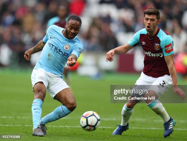 Raheem Sterling of Manchester City gets past Aaron Cresswell of West Ham United during the Premier League match between West Ham United and...