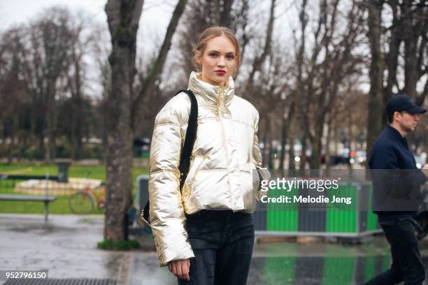 Model Adrienne Juliger wears a gold cropped puffer jacket on January 23, 2018 in Paris, France.