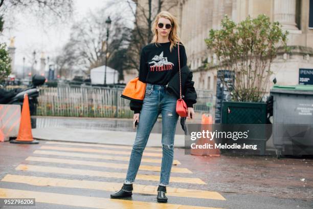 Model Michi Delane wears an Afterlife black tshirt, black puffer jacket off her shoulders, red Chanel bag, blue jeans, and black shoes after the...