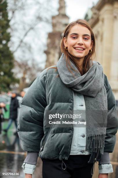Dutch model Romy Schonberger wears a gray scarf and green soft puffer jacket on January 23, 2018 in Paris, France.