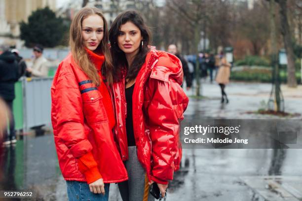 Models Michelle Gutknecht, Alex Binaris both wear cropped red coats after the Chanel show on January 23, 2018 in Paris, France.