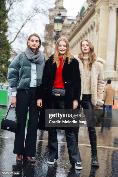 Dutch models Romy Schonberger, Roos Abels, Lauren de Graaf after the Chanel show on January 23, 2018 in Paris, France. Romy wears a gray scarf, green...